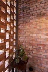 British-Indian architect Laurie Baker, known for pioneering low-cost, climate-responsive housing in India, was a key influence on the project. “We drew from his idea of the jaali—the perforated brick wall—as a way to break up the vertical volume of the vaulted space,” says Sasidharan. “It helped with everything from ventilation to light filtering, while also giving the home a sense of openness.”