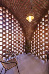 The light pendant upstairs is crafted from screw pine, a plant traditionally used in local craft. “We came across it while travelling through Cochin and bought it from a local artisan to use in a future project like this,” says architect Neenu Elizabeth. The chairs were left over from a previous project by NO Architects.