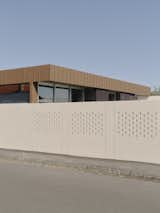 A new white brick wall surrounds the home, offering a more engaging and welcoming street presence.