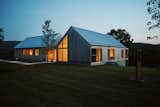 The home is clad in a yellow Alaskan cedar timber, which will silver as it patinas to create a soft palette of greys with the galvanized roof and gutters. "I wanted the house to be different levels and textures of gray," says Michael.