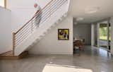 The home is set into the sloped site, meaning there are windows only on one side of the lower floor. The large windows in the stairway, however, flood the space with natural light. "That's an unusual experience for being below ground," says Dalesio. "Having that much light spill into that space is particularly special."  