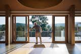 The Meadows features a cantilevered balcony that overlooks the meadow and lap pool. Marvin Ultimate Sliding doors and matching white oak frames extend the home’s warm interior palette and frame views of the surrounding landscape. 