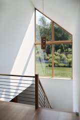It was essential that the stairwell have a large glazed area to get light into the lower areas—which proved challenging due to the unusual shape that follows the roofline. "With Marvin Ultimate windows, we were able to break that up into four custom windows that assemble together into one enormous glazed wall," says architect Nate Dalesio. "We were able to subdivide it exactly how we wanted, which was perfect." 