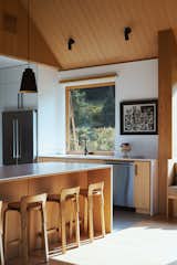 The home features floor-to-ceiling windows and doors from the Marvin Ultimate collection as well as a combination of smaller casements and awnings. "It breaks up those large openings and gives them more of a human scale when you’re opening and closing the windows," explains architect Nate Dalesio. The vintage bar stools seen here are by Alvar Aalto.