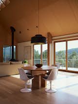 The floor-to-ceiling Marvin Ultimate Sliding doors in the living and dining area lead to the cantilevered deck and frame uninterrupted views of the surrounding meadow and hills while flooding the space with natural light. 