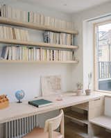A built-in desk and shelving unit crafted in oak make the study a serene place for Dan to work from home. “The joinery is what links the geometry of the mansard and the curved walls,” says architect Oliver Cooke. “It makes the space feel sculpted rather than fitted in.”