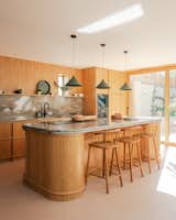 The kitchen features oak joinery and a worktop crafted from a rare, green-veined marble with bullnose edges. “Every time I see the kitchen, I’m glad that we went for that stone,” says homeowner Leila D'Angelo. “It’s just so unique.”