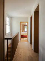 The timber flooring and plaster walls are now continued upstairs—a last-minute decision with a big impact.