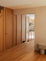 The couple have two sphynx cats and the home has been designed around their needs as well as the family's. The joinery under the staircase, for example, houses a litter box that is accessible through a cat opening. "There's a lot of hidden infrastructure that supports their furry friends,