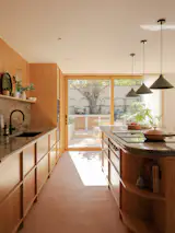 The kitchen connects directly with the outdoor space, expanding the living area.