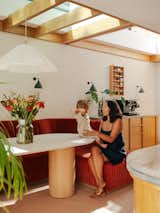 Leila D'Angelo, a brand consultant and passionate sewer in her spare time, with her son in the new kitchen, which features bespoke banquet seating inspired by welcoming hospitality interiors.