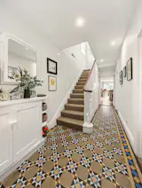 <span style="font-family: Theinhardt, -apple-system, BlinkMacSystemFont, "Segoe UI", Roboto, Oxygen-Sans, Ubuntu, Cantarell, "Helvetica Neue", sans-serif;">The existing entrance felt dated and worn, and was in need of updating—with the exception of the curved timber handrail on the stair. </span><span style="font-family: Theinhardt, -apple-system, BlinkMacSystemFont, "Segoe UI", Roboto, Oxygen-Sans, Ubuntu, Cantarell, "Helvetica Neue", sans-serif;">“The stair was in a bit of a state, but the handrail was beautiful solid timber,” says Benjamin. “To make that now would be prohibitively expensive.” </span>