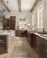 The ILVE Majestic II 60” Dual Fuel Range in burgundy with burnished trim adds depth and drama to the kitchen, picking up on the warm tones of the two-tone millwork. Other appliances have been hidden behind timber panels so that they seamlessly blend into and sit flush with the cabinetry.