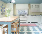 This pastel-hued kitchen by Kvänum takes inspiration from the Art Deco era and features the ILVE Majestic II 48” Induction Range in white with chrome trim. The range features eight black brass gas burners and a griddle with non-stick nanotechnological coating.