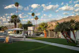 The low-rise bungalows sit across three manicured acres, with the San Jacinto Mountains providing a dramatic backdrop.