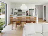The open-plan kitchen, dining, and living area embodies the Edwards’ principle of "soft contrast," with pared-back interiors that counterbalance the home’s dark exterior. A Thos. Moser walnut dining set anchors the space beneath a sculptural white pendant, while a large picture window draws the surrounding woods into the room.