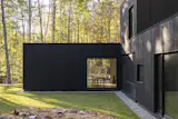 One of the home's defining qualities is its transparency—large picture windows on opposing walls allow views clean through the structure to the woods beyond. "We've been pleasantly surprised by how the large windows and ‘see through’ aspects of the house allow us to observe a lot of wildlife moments we might otherwise miss," says homeowner, Katie.