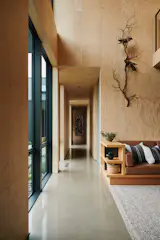 “The outside is dark, the inside is natural – it’s like peeling back a charred log,” says Deana of the contrast between the shou sugi ban exterior and the pale mass plywood interior. The black trim of the Marvin Ultimate window frames sharpen that contrast.