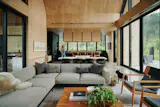 Mass plywood lines the walls, ceilings, and much of the cabinetry in the main living space, giving the interior a warm, cabin-like character despite its generous scale.