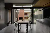 The living and dining areas look onto the central courtyard, where the original kitchen hearth has been rebuilt as an outdoor fireplace. “We had to rebuild it because it was falling down, but we used the same bricks and just cleaned it up,” says Stanley.