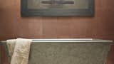 Concrete cladding and soaking tub. The cladding is in Copper MetalCrete® finish and the tub is in Pewter.