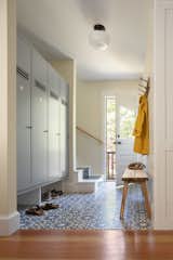 Mudroom with custom wood lockers, designed by Caleb Johnson Studio and fabricated by Woodhull of Maine. Concrete floor tiles. 