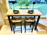 ESCAPEROO ONE - An adjustable dining table at counter height with electrical hook-up and USB charging. A large picture window floods in lots of light.