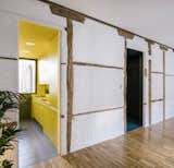 The 323-square-foot BYG House in Spain updates Paleolithic dwelling typology with bold colors and multifunctional spaces. Madrid-based Gon Architects divided the layout into three distinct spaces designated by the colors teal, yellow, and off-white.