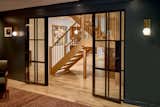 View from the lounge through the new steel doors back to refurbished staircase and relocated kitchen