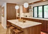 New kitchen with custom walnut cabinetry giving contrast to all of the other white oak accents in the open first floor plan.
