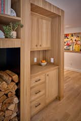 New custom built-ins for dining room and firewood storage in the stair & fireplace central column