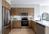 Kitchens  at The Ballantine come equipped with stainless steel appliances, Silestone countertops, full-height tiled backsplashes, and soft-close cabinetry.