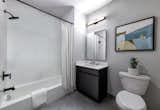 Bathrooms feature porcelain tile floors, Silestone vanity countertops, and full-height ceramic tiled walls