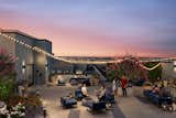 Amenities at The Ballantine are designed to enhance residents' lifestyles, including concierge services, a rooftop deck with lounge areas, and courtyard with BBQs and dining spaces