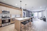 Homes at The Marq offer luxury kitchens equipped with full-size stainless steel appliances, soft-close cabinetry, polished quartz countertops, and large kitchen islands in select residences