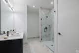 Lavish baths feature matte tiled floors and shower walls.