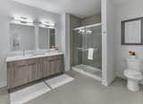 Lavish bathrooms feature custom vanities, glass tub/shower doors, chrome Moen faucets, quartz countertops and mosaic tiled backsplash.