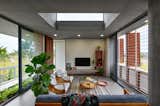 Living - consistent in the entire house is the neutral base palette of grey(concrete and flooring tiles) and white(walls) letting soft furnishings add a pop of color.