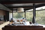 The use of wood on the floors, walls and ceilings give a cocooning effect while the floor to ceiling windows add light and space.