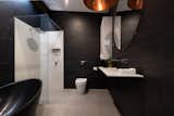 Bold black and white are used in both bathrooms 