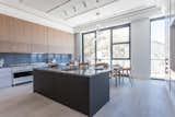 Kitchen, Drop In Sink, Pendant Lighting, Marble Backsplashe, Marble Counter, Ceiling Lighting, White Cabinet, and Cooktops Main kitchen  Photo 15 of 27 in The Estate Penthouse by Tatum Brache