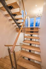 Custom single stringer stairs.  Locally sourced Fir for the treads and handrail.  Cable railings help keep everything light and sexy, and create wonderful shadows with the afternoon sun beaming through the three large stair tower windows