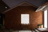The entryway washes the original brick wall with light.