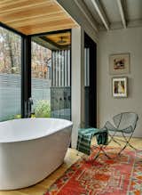 Primary bath, view to outdoor shower and kitchen garden