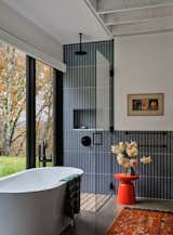 Guest bath, view north to woods, the window in the bath opens to extend the feeling of an outdoor experience