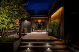 Exterior view from the Pool deck to the entryway at night 