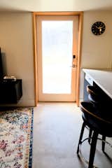 The backsplash design by local artist Carson Abbert, continues into the frosted pattern on the glass entrance door.