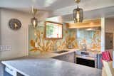 Concrete countertops in the kitchen with glass backsplash.  Backsplash design by Carson Abbert.
