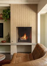 Modular fireplace with poured in place concrete slab and textured tile front.