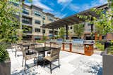 A lushly landscaped terrace includes BBQ grills, dining areas and fire pits.